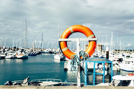 Orange buoy in the port of l'Herbaudiere on the island of Noirmoutier, France