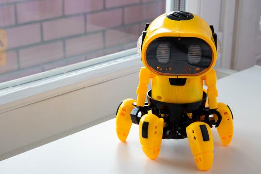 A child's toy, a yellow robot. image isolated on a white background.