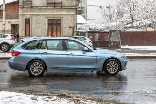 Snow on cars in the morning. Winter season, icy cars. Winter concept, frozen cars on the road in Bucharest, Romania, 2021