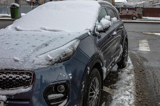 Snow on cars in the morning. Winter season, icy cars. Winter concept, frozen cars on the road in Bucharest, Romania, 2021