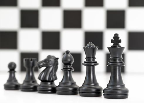 Close up Set of black chess pieces on chessboard, Set of chess figures on white background