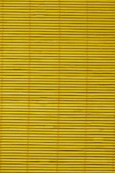 Close-up of the wooden blinds on the mustard-colored windows.Texture or background