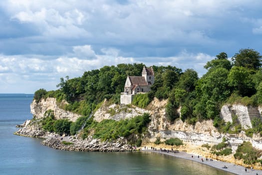 Hojerup, Denmark - July 21, 2020: View of Stevns Klint cliff and the Old Hojerup Church