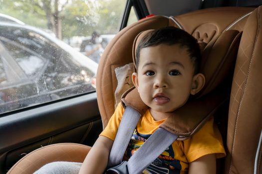 Close-up of little boy children on a car seat in the car.