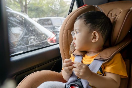 Close-up of little boy children on a car seat in the car.