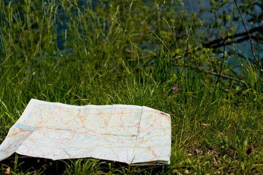 Map of Germany lies on the green grass.