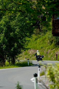Plansee lake, Austria - June 20, 2017: The motorcyclist rides along the road along the lake.
