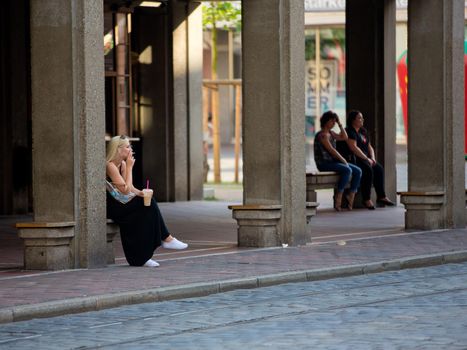 Augsburg, Germany - June 18, 2017: The girl smokes at the tram stop.