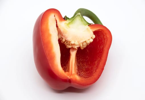 Half of red bell pepper in cut on white background.