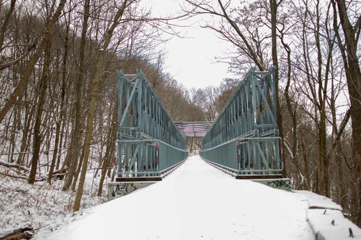 A metal bridge with snow covering it. High quality photo