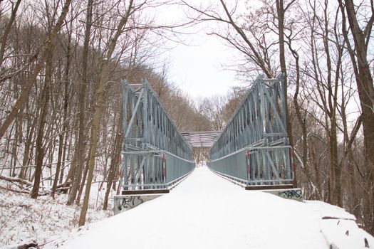 A metal bridge with snow covering it. High quality photo