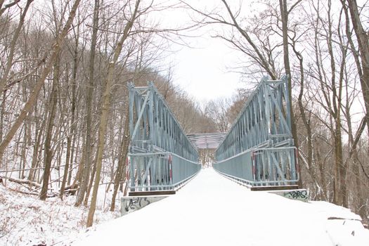 A metal bridge with snow covering it. High quality photo