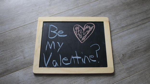 be my valentine wrote on a chalk board. High quality photo