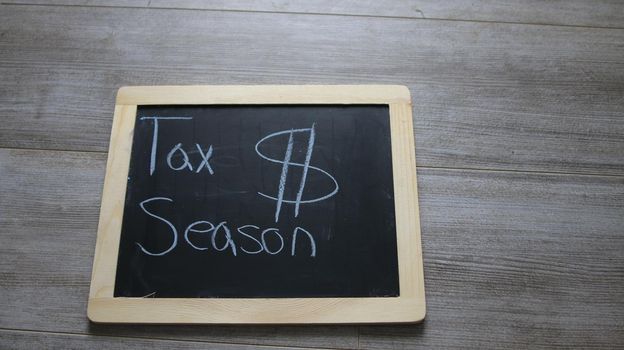 tax season wrote on a chalk board. High quality photo