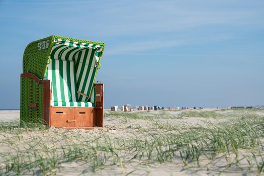 Beach chairs at the coastline of Amrum, North Frisia, Germany 