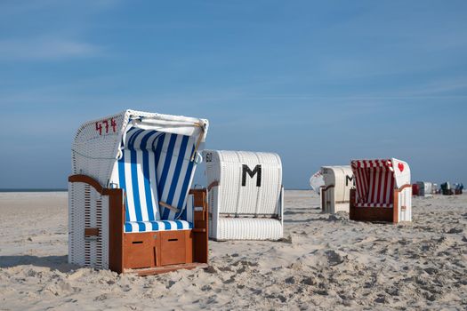 Beach chairs at the coastline of Amrum, North Frisia, Germany 