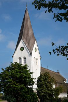 Old church of Nebel against blue sky, Amrum, Germany