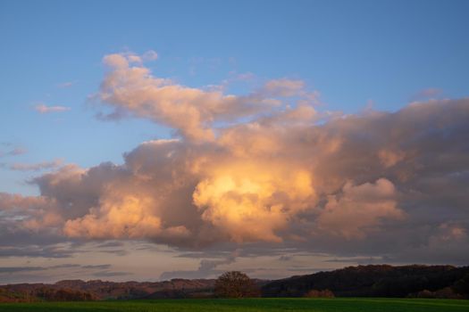 Early morning landscape with pastel-colored clouds
