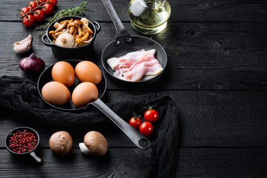 Healthy breakfast ingredients for fried eggs set, on black wooden table background , with space for text copyspace