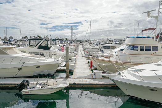 Boats moored at Embarcadero Marina Park North, San Diego. Boat, yachts, ship and sail docked at the harbor. Marina with anchored luxury boats. California. USA. January 16th, 2021