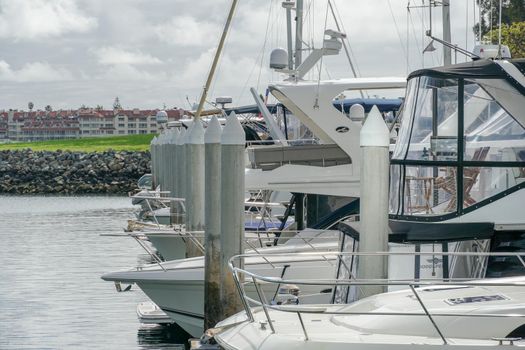 Boats moored at Embarcadero Marina Park North, San Diego. Boat, yachts, ship and sail docked at the harbor. Marina with anchored luxury boats. California. USA. January 16th, 2021