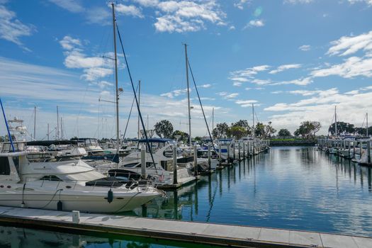 Boats moored at Embarcadero Marina Park North, San Diego. Boat, yachts, ship and sail docked at the harbor. Marina with anchored luxury boats. California. USA. January 16th, 2021