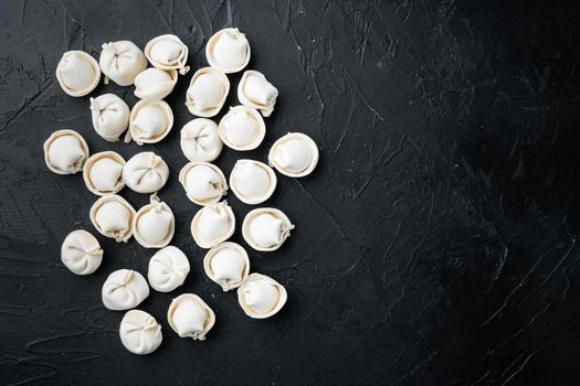 Frozen tortellini set, on black background, top view flat lay , with copyspace and space for text