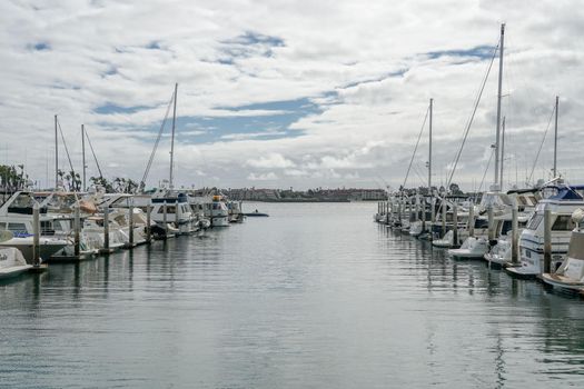 Boats moored at Embarcadero Marina Park North, San Diego. Boat, yachts, ship and sail docked at the harbor. Marina with anchored luxury boats. California. USA. January 16th, 2021