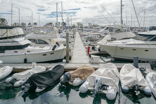 Boats moored at Embarcadero Marina Park North, San Diego. Boat, yachts, ship and sail docked at the harbor. Marina with anchored luxury boats. California. USA. January 16th, 2021