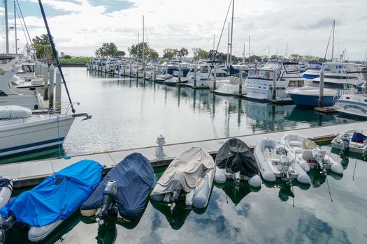 Boats moored at Embarcadero Marina Park North, San Diego. Boat, yachts, ship and sail docked at the harbor. Marina with anchored luxury boats. California. USA. January 16th, 2021