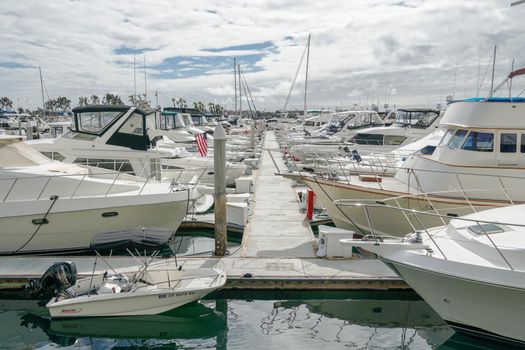 Boats moored at Embarcadero Marina Park North, San Diego. Boat, yachts, ship and sail docked at the harbor. Marina with anchored luxury boats. California. USA. January 16th, 2021