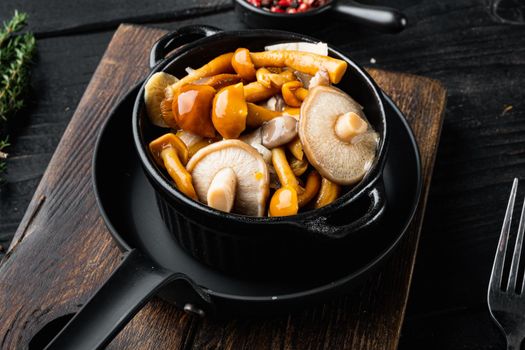 Fermented food: Mushroom preservation set, on black wooden table background