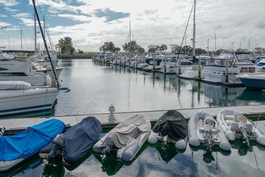 Boats moored at Embarcadero Marina Park North, San Diego. Boat, yachts, ship and sail docked at the harbor. Marina with anchored luxury boats. California. USA. January 16th, 2021