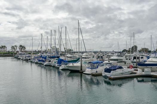 Boats moored at Embarcadero Marina Park North, San Diego. Boat, yachts, ship and sail docked at the harbor. Marina with anchored luxury boats. California. USA. January 16th, 2021