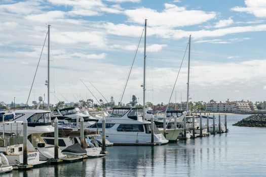 Boats moored at Embarcadero Marina Park North, San Diego. Boat, yachts, ship and sail docked at the harbor. Marina with anchored luxury boats. California. USA. January 16th, 2021