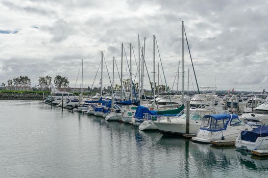 Boats moored at Embarcadero Marina Park North, San Diego. Boat, yachts, ship and sail docked at the harbor. Marina with anchored luxury boats. California. USA. January 16th, 2021