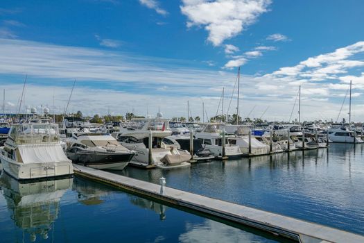 Boats moored at Embarcadero Marina Park North, San Diego. Boat, yachts, ship and sail docked at the harbor. Marina with anchored luxury boats. California. USA. January 16th, 2021