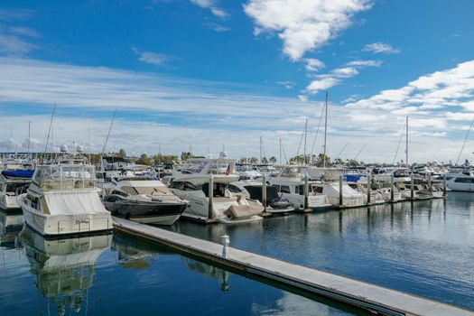 Boats moored at Embarcadero Marina Park North, San Diego. Boat, yachts, ship and sail docked at the harbor. Marina with anchored luxury boats. California. USA. January 16th, 2021