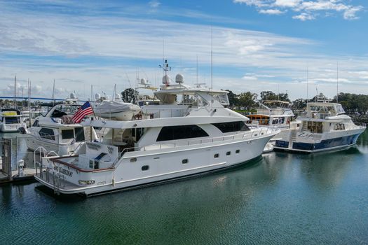 Boats moored at Embarcadero Marina Park North, San Diego. Boat, yachts, ship and sail docked at the harbor. Marina with anchored luxury boats. California. USA. January 16th, 2021