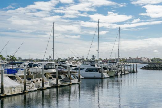 Boats moored at Embarcadero Marina Park North, San Diego. Boat, yachts, ship and sail docked at the harbor. Marina with anchored luxury boats. California. USA. January 16th, 2021