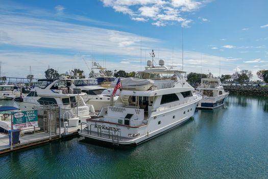 Boats moored at Embarcadero Marina Park North, San Diego. Boat, yachts, ship and sail docked at the harbor. Marina with anchored luxury boats. California. USA. January 16th, 2021