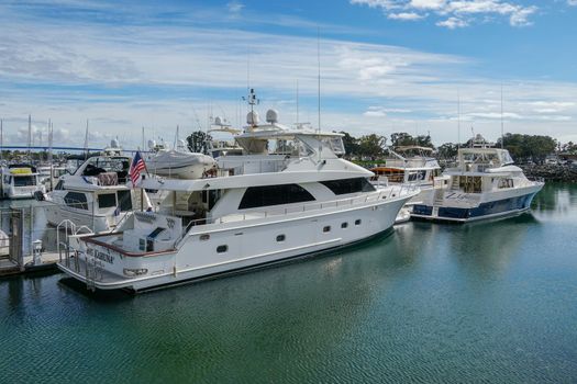 Boats moored at Embarcadero Marina Park North, San Diego. Boat, yachts, ship and sail docked at the harbor. Marina with anchored luxury boats. California. USA. January 16th, 2021