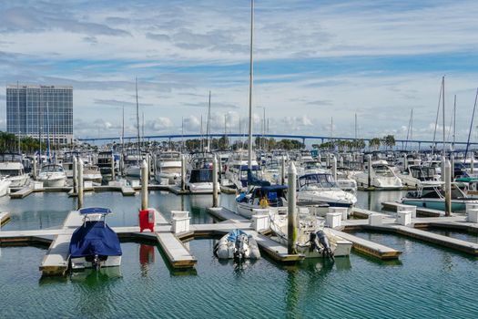 Boats moored at Embarcadero Marina Park North, San Diego. Boat, yachts, ship and sail docked at the harbor. Marina with anchored luxury boats. California. USA. January 16th, 2021