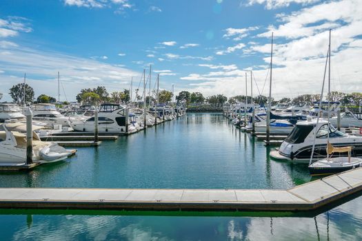 Boats moored at Embarcadero Marina Park North, San Diego. Boat, yachts, ship and sail docked at the harbor. Marina with anchored luxury boats. California. USA. January 16th, 2021