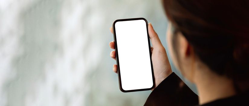 Close up view of a woman using smartphone, Blank screen mobile phone for graphic display montage