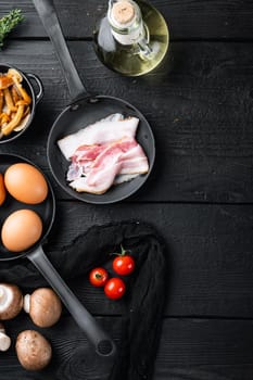 Healthy breakfast ingredients for fried eggs set, on black wooden table background, top view flat lay , with space for text copyspace