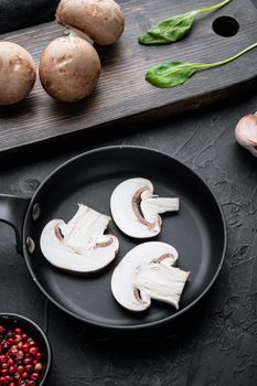 Royal champignons, Parisian champignons set in cast iron frying pan, on black background