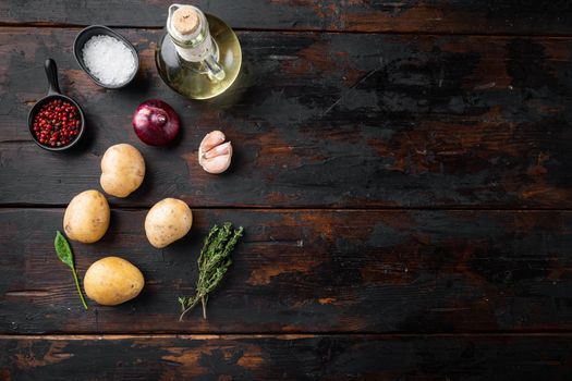 Fresh Pile of potatoes set, on old dark wooden table background, top view flat lay , with space for text copyspace