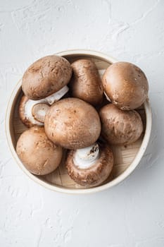 Raw mushrooms champignons set, on white background, top view flat lay