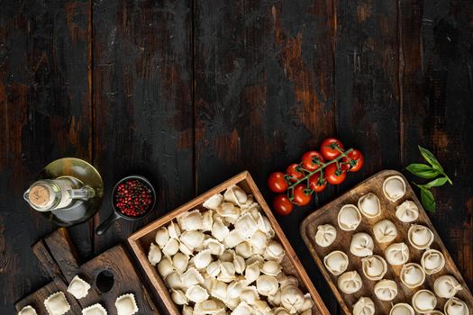 Raw Italian ravioli tortellini with fresh parmesan and basil , tomatoes set on old dark wooden table background, top view flat lay , with copyspace and space for text